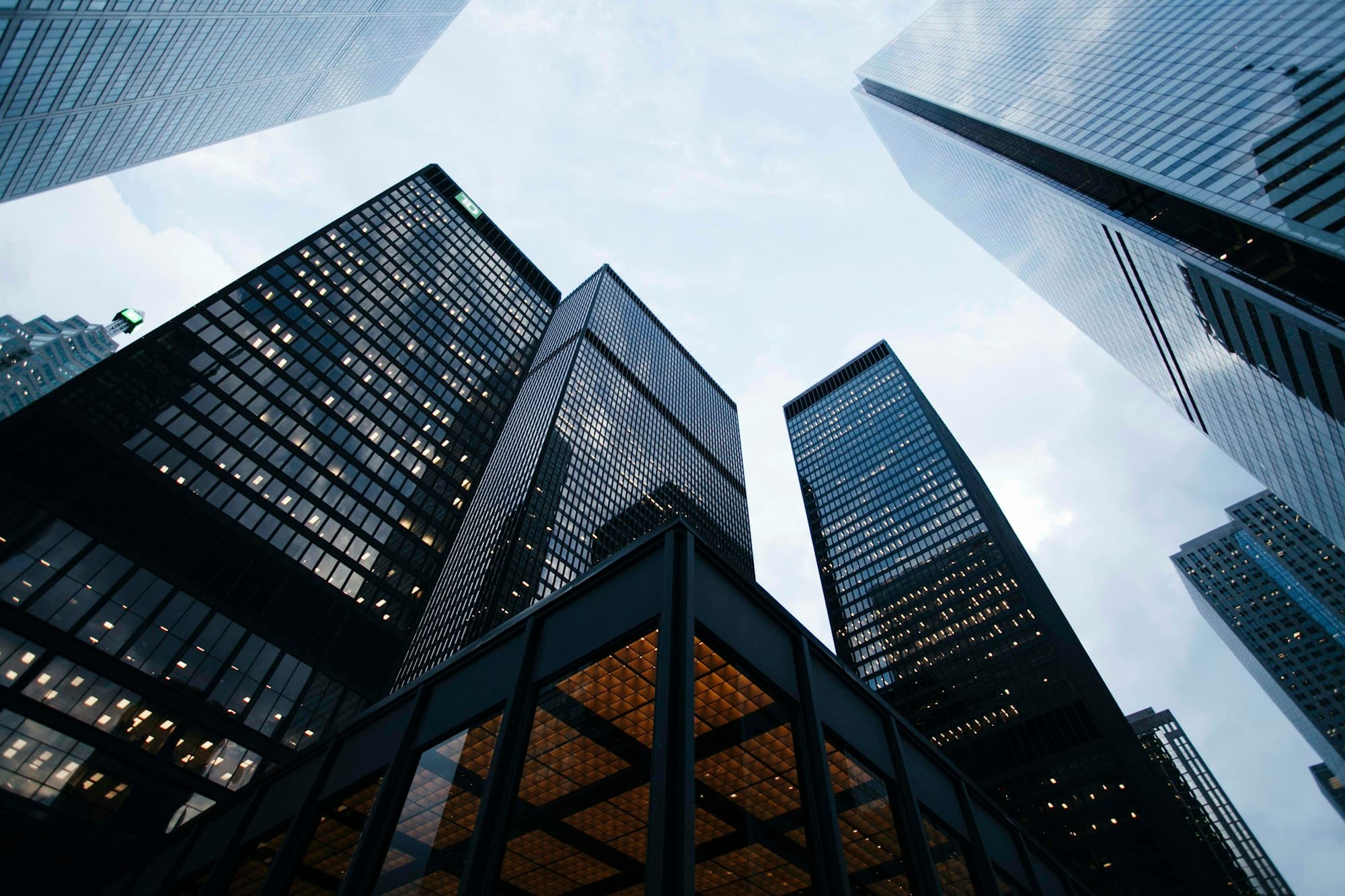 Low-angle photograph of the City of London skyline — 20 Fenchurch Street framed against neighbouring glass facades, the visual signature of the Lloyd's of London market quarter.